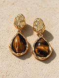 Aretes de broquel o de gota, vista frontal