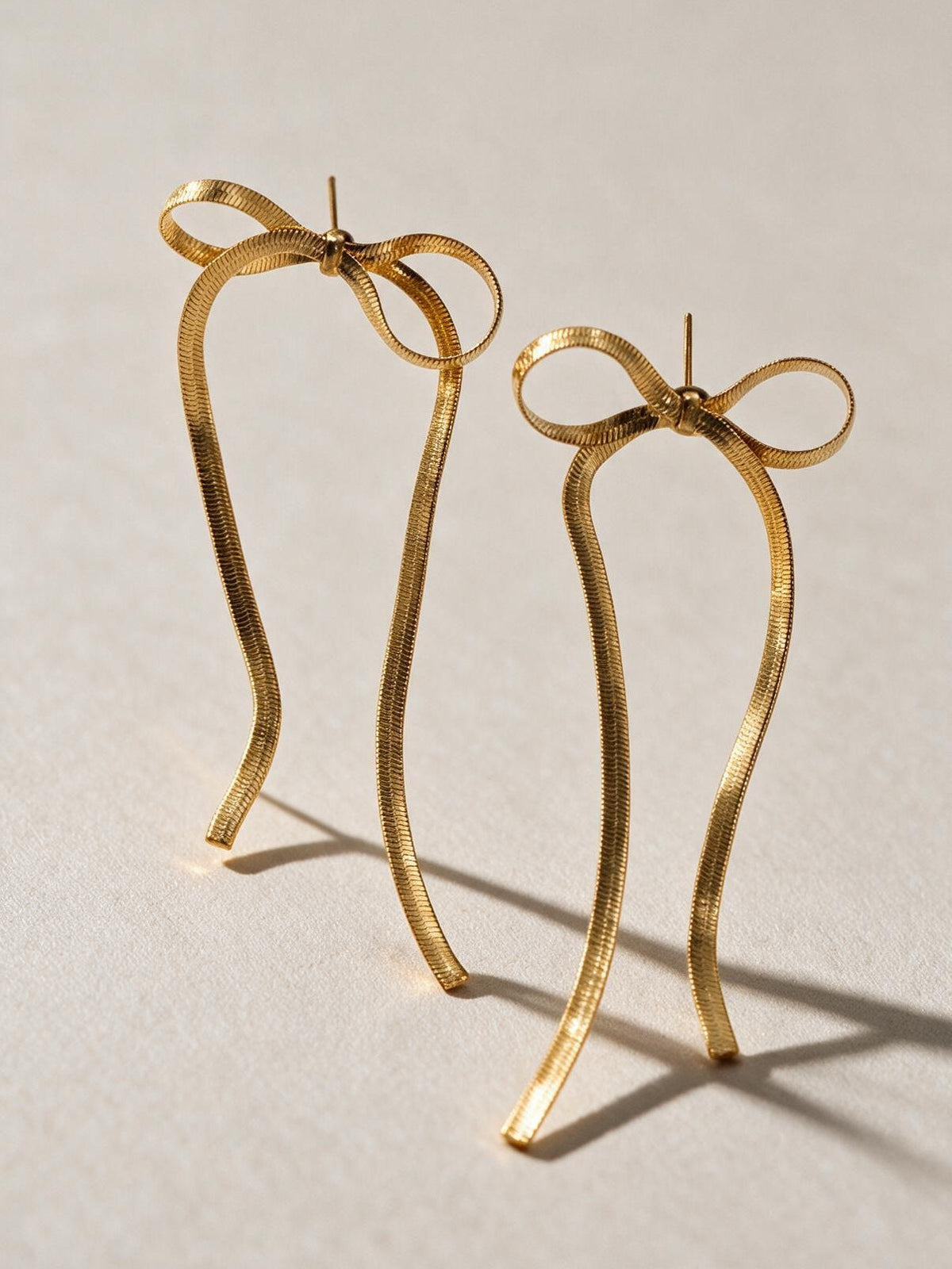 Aretes de línea sencilla, color dorado, vista frontal